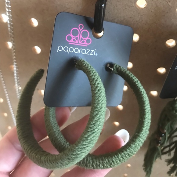 Sage green fabric hoops on posts.